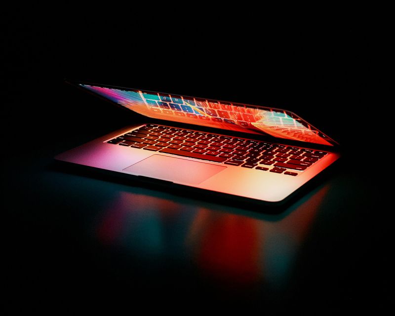 A glowing laptop partially open