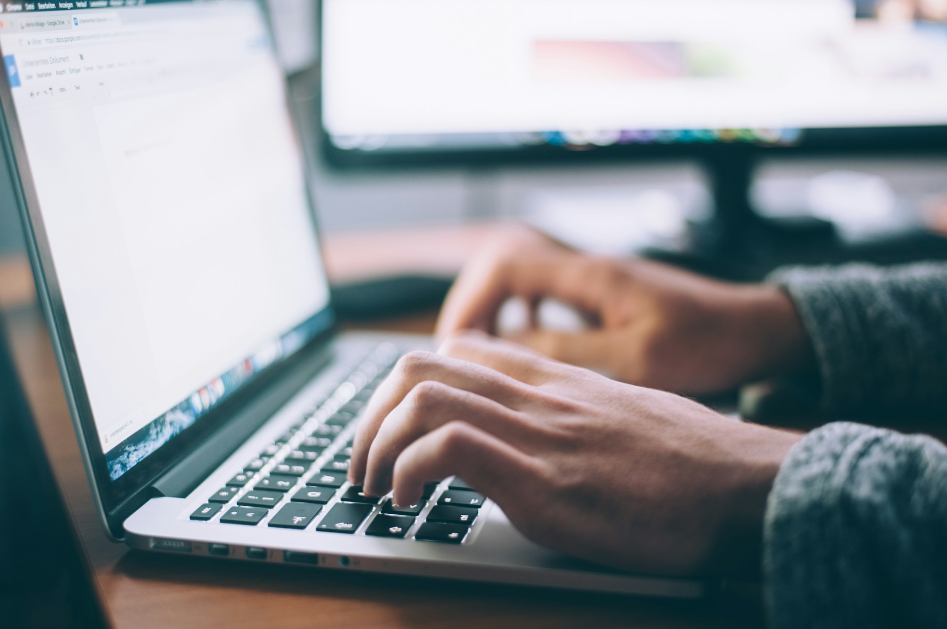 A set of hands on a laptop Keyboard. by Glenn Carstens-Peters